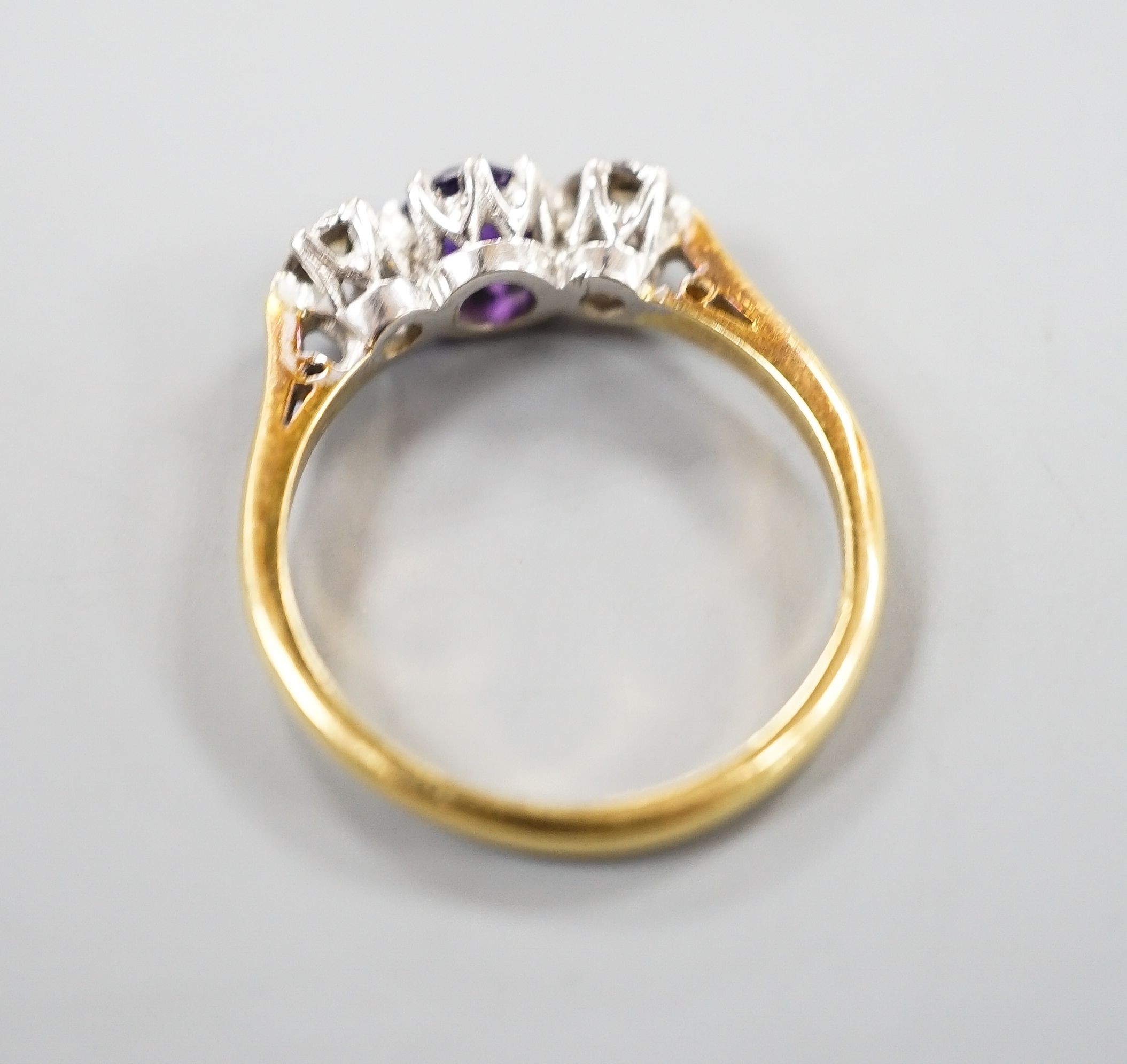 An 18ct, singe stone amethyst and illusion set two stone diamond ring, size, O/P, gross weight 3.7 grams.